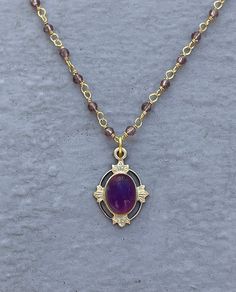 This vintage-inspired necklace is handmade using a 2mm genuine amethyst wire-wrapped chain and a 12x17mm pendant with an authentic 6x8mm amethyst. Amethyst promotes peace, clarity and cleanses energy.  The necklace comes in a ribbon-wrapped box, ready to be gifted. If you would like to leave a note for the recipient, you can do so during checkout. Please note that each stone is unique and varies in color. Gold Amethyst Jewelry With Delicate Chain, Gold Amethyst Bohemian Necklace, Elegant Gold Amethyst Crystal Necklaces, Bohemian Gold Amethyst Necklaces, Purple Amethyst Oval Pendant Necklace, Bohemian Amethyst Gold Necklace, Handmade Amethyst Gold Necklace, Gold Amethyst Necklace With Gemstone Beads, Handmade Gold Amethyst Necklace