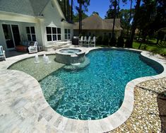 a backyard with a pool, patio and lounge chairs on the side of the house