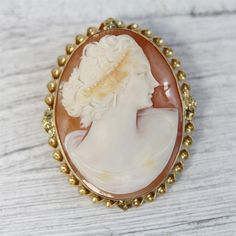 HERE ARE THE DETAILS YOU NEEDN6014Antique 14K Yellow Gold Carved Shell Cameo Brooch Pendant Pretty Lady LuxuryBEAUTIFUL LADY WITH HEADRESS, EARRINGS HAND CARVED SHELL CAMEO. FINEST DETAIL AMAZING BROOCH PIN WONDERFUL HIGHEST QUALITY. JUST PART OF MY MOST RECENT ESTATE FINDS! FOLLOW ME TO SEE THEM ALL! Metal Purity: Metal: 14K Yellow GoldMaterial: Carved Shell CameoForm: Brooch Pendant Pretty Lady LuxurySize :1 3/4 x 1 1/2"Age: AntiqueWeight (Grams): 11.8IT IS IN VERY FINE ESTATE CONDITION Exquisite Yellow Gold Brooch For Anniversary, Luxury Gold Brooches With Cabochon, Anniversary Oval Brooches, Elegant Cameo Brooch For Formal Wear, Elegant Formal Brooch With Intaglio Detail, Elegant Intaglio Brooch For Formal Occasions, Luxury Intaglio Brooch For Formal Occasions, Elegant Formal Cameo Brooch, Oval Brooches For Formal Occasions