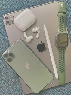 an apple watch, headphones, and other electronics on a table