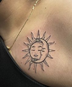 a woman's chest with a sun and moon tattoo on it