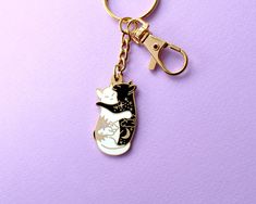 a keychain with a black and white cat on it