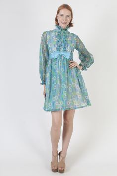 Vintage 60s mod Go-Go scooter mini dress. Tailored bodice with long sheer sleeves and high neckline. Blue all over floral print polyester material. Dress is lined and zips up the back. size estimate: S shoulders: 15" bust: 34" waist: 27" hips: 38" total length: 34.5" Model is 5'9" and measures 32" bust, 25" waist, 34" hips. Belts/accessories are not included unless noted in the description. * Visit the shop * https://www.etsy.com/shop/americanarchive Gogo Outfit, Gogo Outfits, Vintage Scooter, Mod Mini Dress, Material Dress, Outfit Vintage, 60s Mod, 60s Dress, Ruffle Mini Dress