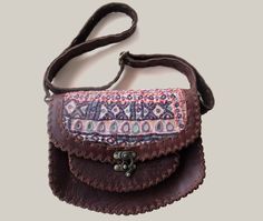 This leather bag is perfect for those who love the boho style and unique pieces. + Handcrafted from genuine leather and Banjara fabric, each bag is unique. The design features a vibrant combination of colors and patterns, which are inspired by traditional Banjara crafts in India. + The size is perfect for carrying everything you need, from your wallet and phone to your keys and cosmetics. Plus, the adjustable strap allows you to wear it as a crossbody bag or as a handbag. This bag is a true statement of style and quality. Each piece is carefully handcrafted with attention to detail meaning you get a unique and long lasting piece. + If you are looking for a unique leather bag that makes you feel good and elegant, then this Banjara Leather Bag is the perfect choice. + FEATURES: + Handmade le Unique Leather Bag, Ethnic Bag, Idea Gift, Leather Bags Handmade, Leather Cross, Gift For Girlfriend, Bag Handmade, Hippie Style, Bag Women