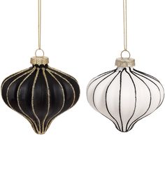 two black and white ornaments hanging from strings