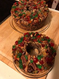 two cakes are decorated with candy and nuts