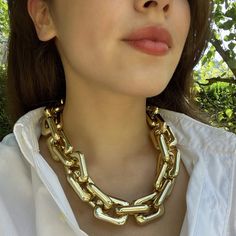 Make a bold statement with this stunning gold resin link chain necklace. Designed for those who embrace daring fashion, this lightweight piece offers a striking contrast that effortlessly elevates any outfit. Whether paired with a casual white t-shirt or dressed up for a business lunch, its versatile design ensures you stand out with confidence. A timeless accessory, this necklace is a must-have for anyone who adores statement jewelry with a classic edge. Avoid contact with water and cosmetics, Trendy Chain Link Necklaces For Party, Trendy Chain Link Necklace For Party, Chunky Link Chain Necklace For Party, Party Necklaces With Chunky Chain Links, Bold Link Necklaces, Modern Party Necklaces With Chain Strap, Bold Chunky Chain Necklace, Trendy Party Gold Chain Necklace, Bold Necklaces With Adjustable Chain