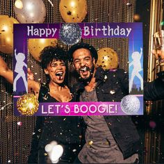 two people standing in front of a photo booth with balloons and confetti