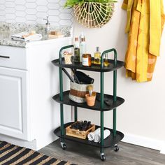 a bathroom with a sink, towel rack and other items on the floor next to it