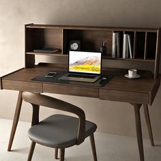 a desk with a laptop on it next to a chair