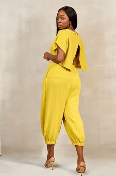 Color you yellow. Look up style in the dictionary and you're sure to find this jumpsuit! Features Relaxed open back with button closure Harem style pants Drawstring elastic waistband Elastic cuffs Side pockets CONTENT & CARE Hand wash with cold water Cotton DEETS & FIT Model is wearing a size Medium Fabric has some stretch in waistband Model profile: Uche is 5'9" and measures 34 (bust) 27 (waist) and 45 (hips) Model Profile, Harem Jumpsuits, Model Profiles, Style Pants, Drawstring Pants, Pet Hair, Up Styles, Open Back, Fitness Models