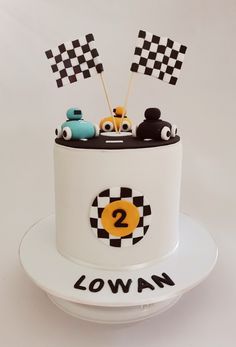 a birthday cake with cars and flags on top