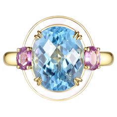 Introducing our stunning "Blue Topaz and Pink Sapphire" ring - a perfect combination of elegance and playfulness. This high-end jewelry piece features a beautiful 4.85 carat oval cut blue topaz, accented on each side with 0.39 carat of pink sapphire. The blue topaz is held securely in place with double claws on each corner of the stone, while the ring's halo is adorned with white tone enamel, adding a touch of modern and artistic flair to the design. Crafted from high-quality 18 karat yellow gold, this ring is available in US size 6.5 with resizing options available. It's the perfect choice for those looking to add a touch of sophistication to their everyday style, or for special occasions. US 6.5 Resizing is available 18 Karat Yellow Gold Blue Topaz 4.85 carat Pink Sapphire 0.39 carat Whi Art Deco Cocktail, Enamel Art, Pink Sapphire Ring, Blue Sapphire Rings, Halo Rings, White Enamel, Cocktail Ring, Jewelry Handmade, Pink Sapphire