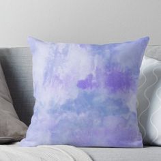 a blue and purple pillow sitting on top of a couch