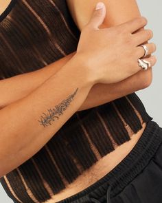 a woman's arm with a tattoo on it