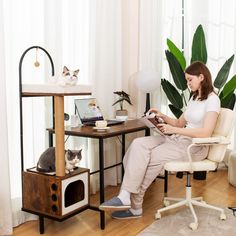 a woman sitting in a chair with a cat on her lap looking at the screen