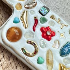 a white tray filled with lots of different types of sea glass and seashells