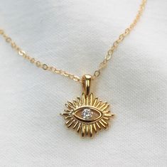 Spiritual Gold Eye-shaped Necklace, Gold Spiritual Necklace With Diamond Eyes, Gold Dainty Necklace With Diamond Eyes, Dainty Gold Necklace With Diamond Eyes, Gold Symbolic Charm Necklaces With Evil Eye, Gold Symbolic Evil Eye Charm Necklaces, Symbolic Gold Evil Eye Charm Necklaces, Dainty Gold Eye-shaped Jewelry, Everyday Gold Charm Necklaces With Evil Eye