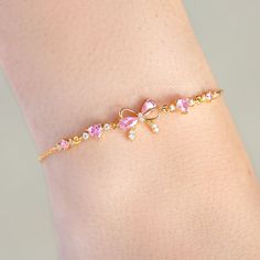 Tie your style together with our Little Bow Peep Bracelet– a sweet and chic accessory that's the 'knot'-ty solution to your fashion needs! This bracelet features a dainty pink bow, adding a touch of playful elegance to any outfit. This bracelet is the perfect way to add a 'bow-tiful' finishing touch to your look! Big And Little Sorority Gifts, Gold Bow Jewelry, Mommy And Me Jewelry, Coquette Charm Bracelet, Gold And Pink Jewelry, Coquette Bracelets, Cute Pink Things, A Lot Of Bracelets, Cute Girly Things