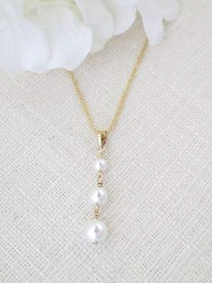 Simple and sophisticated is this graduated pearl pendant necklace. Swarovski pearls in step fashion measure 4mm, 5mm and 6mm dangling from a 14kt gold filled bail. Pearl Drop Necklace For Wedding, White Pearl Drop Backdrop Necklace, Elegant Drop Pearl Necklace For Anniversary, Pearl White Drop Necklace For Wedding, Wedding Pearl Drop Dangle Necklace, Pearl White Pearl Drop Wedding Necklace, Anniversary Pearl Drop Necklace, Pearl White Wedding Drop Necklace, Anniversary Drop Pearl Necklace