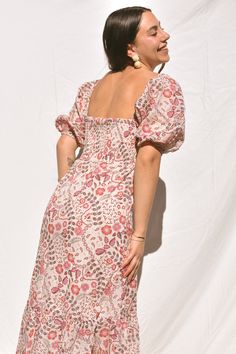 Sometimes you just need that everyday dress that's equal parts comfortable and cute. Our Dahlia Floral Maxi dress is cut from cotton pink, purple and mocha floral/paisley print fabric. Classic column dress silhouette with a button-down front, soft blouson sleeves and smocked back. You can wear the sleeves on or off the shoulders to give you a variety of different looks. This is the perfect bohemian dream dress! Mauve Floral Print Dress For Garden Party, Mid-length Cotton Floral Dress, Mauve Floral Print Summer Dress, Pink Cotton Midi Dress With Smocked Bodice, Fitted Mauve Floral Print Dress, Pink Bohemian Dress With Gathered Sleeves, Bohemian Paisley Print Daywear Dresses, Spring Floral Print Mauve Dress, Pink Puff Sleeve Cotton Midi Dress