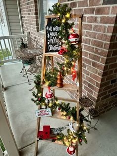 a ladder decorated with christmas decorations on the front porch