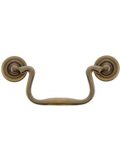 an antique brass towel hook on a white background