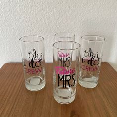 three shot glasses with the words mr and mrs on them sitting on a wooden table