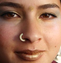 Lakshmi / laxmi The Hindu goddess of wealth, fortune and prosperity be the goddess that you are! be the goddess that you are! A beautiful tribal jewelry, made from 14K solid yellow gold and love ~ Can be used as a tragus / nose ring / septum / single earring / helix / lip ring/ daith ~ Size of the nose ring: Inner diameter : 1/4, 5/16 or 3/8 inch (7,8 or 9 mm) Wire gauge : 22,20,18 or 16 ( 0.6, 0.8, 1 or 1.2 mm) ~ For larger sizes and special requests please contact me through the' Request custo Gold Nose Rings For Festivals, Elegant Nose Rings For Festivals, Gold Septum Ring For Wedding, Bohemian Gold Nose Rings For Festival, Septum Big Nose, Nose Ring Septum, Unique Nose Rings, Gold Cartilage Earrings, Nose Ring Hoop