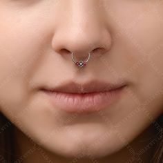 a woman with a nose piercing in front of her face