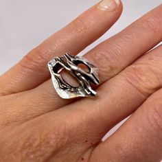 "A custom made designer mid century modernist ring in fine sterling silver.  This unique ring is in lovely condition and is absolute iconic of the era. Dating to the 1970s it could easily grace any coffee table book on fine jewelry design from the period.  In total it weighs 8.1 grams.  The face of the ring itself measures 11/16\" long by 15/16\" wide and rises 5/16\" high off the finger (18mm x 23mm x 8mm).  Currently this amazing hand made custom designed ring is a size 6 3/4. It can be resized to any size required at little cost.  This one of a kind modernist sterling silver ring will be sent in a presentation box." Luxury White Gold Modernist Rings, Modernist Open Band Rings For Formal Occasions, Contemporary Formal Rings With Unique Design, Contemporary Rings With Unique Design For Formal Occasions, Contemporary Ring With Unique Design For Formal Events, Modern Sterling Silver Dome Ring With Open Band, Modern Signet Ring With Polished Finish, Modern Signet Ring With Polished Open Band, Modern Signet Ring With Polished Finish And Open Band