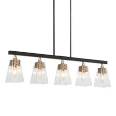 a light fixture with five lights hanging from it's side and four glass shades on the