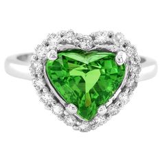 Elevate your jewelry collection with the mesmerizing allure of natural tsavorite in this stunning 18K white gold ring. Accentuated by sparkling diamonds, this exquisite piece combines exceptional craftsmanship with the vibrant beauty of these precious gemstones. Perfect for adding a touch of sophistication, this ring is a versatile and timeless treasure. Center Stone: Natural Tsavorite Quantity & Weight: This ring features a single captivating tsavorite weighing 2.79 carats, making it the striki Tsavorite Garnet, Natural Diamond Ring, Diamond Ring Settings, White Gold Diamond Rings, Modern Ring, White Gold Ring, Three Stone Rings, Color Ring, Exquisite Jewelry