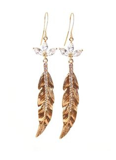 Clip-on style also available! These stunning gold crystal feather earrings make a beautiful statement! Cubic Zirconia flower crystal settings coupled with glass crystal studded gold feathers give these beauties a chic elegant look! 22k gold plated earring hooks add a rich feel, completing the pair! Shop now at KMagnifiqueDesigns.com Gold Feather Earrings For Party, Gold Feathered Jewelry For Parties, Gold Feather Jewelry For Wedding, Gold Feathered Wedding Jewelry, Elegant Dangle Earrings With Feathers, Elegant Dangle Feather Earrings, Elegant Feather Dangle Earrings, Elegant Feather Dangle Jewelry, Gold Feather Earrings As A Gift