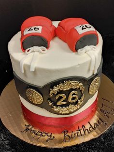 a birthday cake with two boxing gloves on top