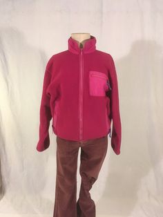 "vintage 1990s women's zip up fleece jacket Patagonia, made in USA 100% polyester trims -100% nylon 86% nylon, 14% spandex pink fuchsia w/purple trim zip up front/side pockets/breast pocket purple cordovan ribbon zipper pull tabs god vintage condition w/light wear zipper up front is a bit wavy (works fine) light wear fade on pocket trim (see photos) label size 10, see below measures, lying flat, shoulder-20\" chest-20 1/2\" sleeve-21\" hem-17 1/2\" to 19\" length-25\"     We do not offer returns Pink Fleece Jacket For Outdoor, Casual Pink Fleece Jacket, Pink Outdoor Fleece Jacket, Pink Fleece Jacket With Pockets For Outdoor, Pink Outdoor Fleece Jacket With Pockets, Pink Fleece Outerwear With Pockets, Casual Pink Fleece Jacket With Pockets, Pink Fleece Jacket For Outdoor Activities, Pink Fleece Outerwear For Outdoor