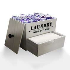 a box filled with lots of purple flowers sitting next to a sign that reads laundry wash dry fold