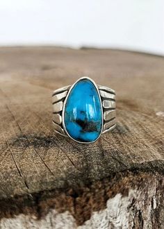 Sterling silver and turquoise with a hand fabricated fan detailing on band. Size: 8 Southwestern Blue Turquoise Teardrop Ring, Handmade Blue Turquoise Teardrop Ring, Handmade Turquoise Teardrop Ring, Handmade Teardrop Turquoise Ring, Artisan Blue Turquoise Ring With Polished Finish, Turquoise Rings With Polished Finish, Blue Sterling Silver Rings With Patina, Blue Sterling Silver Ring With Patina, Southwestern Blue Turquoise Ring With Patina