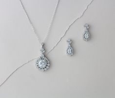 "Lovely simple Sterling silver Bridal necklace set. Created with solid sterling silver base and then plated in rose gold, yellow gold or rhodium (white gold) finish. Stones are Swarovski Pure Brilliance cubic zirconia stones. You can find more information on these stones here: https://www.swarovski-gemstones.com/brand/FAQs_Swarovski_Zirconia.en.html High quality pieces that will last you a life time ! Earrings measure 1\" Necklace measures 18 inches and extends to 20 inches Pendant measures 1.75 Rose Gold Statement Necklace, Rose Gold Jewelry Set, Rose Gold Statement Earrings, Rose Gold Earrings Wedding, Bridal Statement Necklace, Wedding Earrings Chandelier, Gold Bridal Necklace, Wedding Jewelry Set, Crystal Bridal Earrings