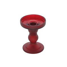 a red glass candle holder on a white background