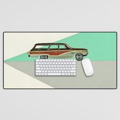 a mouse pad with a car on it and a keyboard in front of the mouse