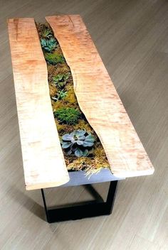 a wooden bench with plants growing on it's sides and some grass in the middle