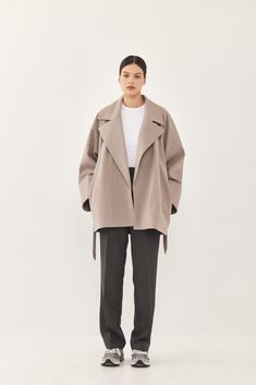 A heavy weight rode coat. An oversize fit with long voluminous sleeves and side pockets. Features a lapel collar with an embroidered logo. Comes with a detachable waist belt. A cozy worm coat you can wear over any outfit. 100% Polyester Color: Beige tone fishbone Care: Dry clean only Oversize fit, side down for a slimmer look. Model wears: M Model's fit:1.75 cm Waist 59 cm Hips 86 cm Bust 78 cm How to measure yourself Voluminous Sleeves, Fish Bone, Model Fits, Grey And Beige, Sweaters Knitwear, Lapel Collar, Waist Belt, Heavy Weight, Short Pants