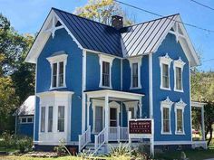 a blue house with white trim and windows