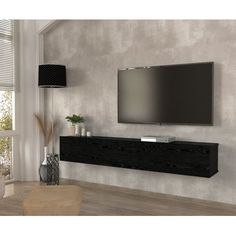 a flat screen tv mounted to the side of a wall