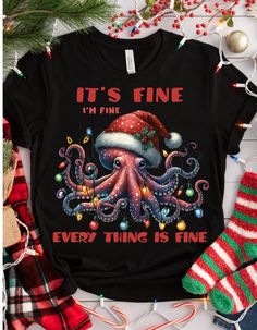 CHRISTMAS INTROVERT SHIRT - It's Fine I'm Fine Everything is Fine Shirt, Christmas Octopus Shirt, Motivational Tee, Everything is Fine Shirt Celebrate the holiday season with a touch of introverted humor and a splash of festive flair in our Christmas Introvert Shirt. Perfect for those who appreciate a bit of motivation with their Christmas cheer, this tee is both comfy and stylish! Key Features: Material: 100% cotton for a soft, breathable wear. Variations include: Sport Grey: 90% cotton, 10% polyester Ash Grey: 99% cotton, 1% polyester Heather colors: 50% cotton, 50% polyester Fabric Weight: 5.0-5.3 oz/yd² (170-180 g/m providing a sturdy and comfortable fit. Design: Features a quirky "It's Fine I'm Fine Everything is Fine" message with a playful Christmas octopus graphic, adding a humorou Christmas Octopus, Octopus Graphic, I'm Fine, Holiday Wardrobe, Everything Is Fine, Christmas Cheer, Christmas Shirts, Funny Gifts, The Holiday