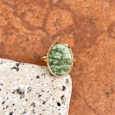 Estate/ vintage 10KT yellow gold oval, genuine green jade ring. Beautiful, earthy green jade set on a low profile setting. Size 6 Weight: 2.60 grams Band width: 2mm Jade measures: 14mm x 10mm Stamped 10KT Excellent estate condition Oval Jade Jewelry With Natural Stones, Oval Jade Rings In Yellow Gold, Green Oval Gemstone Rings, Green Oval Gemstone Jewelry, Oval Green Jewelry With Polished Finish, Oval Green Natural Stone Jewelry, Green Oval Natural Stone Jewelry, Green Oval Rings With Natural Stones, Oval Jade Ring With Natural Stones