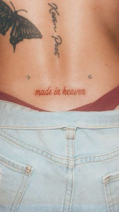 a woman's stomach with the words made in heaven written on her lower back