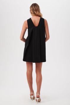 This sleeveless shift dress offers a timeless A-line silhouette with a short cocktail length, a round neckline, and an inverted back pleat for an elegant finish. Round neckline V-back Decorative, jeweled neckline Sleeveless Inverted back pleat Side zipper A-line silhouette Length: 37" Runs true to size Model is 5'10", wearing size 2 See Women's Size Guide FABRIC: Luxe Drape Suiting 63% Polyester, 32% Viscose, 5% Spandex Machine or hand wash cold Imported Jewel Neckline, Sleeveless Shift Dress, Black Shorts, Side Zipper, Round Neckline, Shift Dress, A Line Dress, Size Guide, A Line