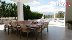 an outdoor dining area with table, chairs and pool in the backgroung